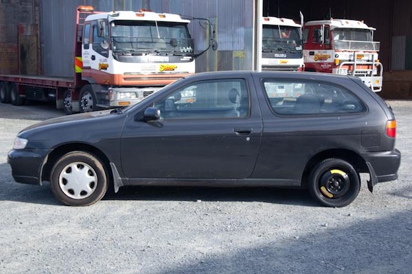 Carmen's black Nissan Pulsar car, with the registration number ATS209